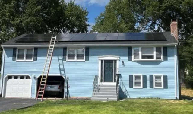 Rooftop solar panels on a blue home