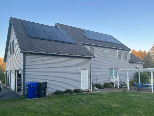 Gray residential home with rooftop solar panels