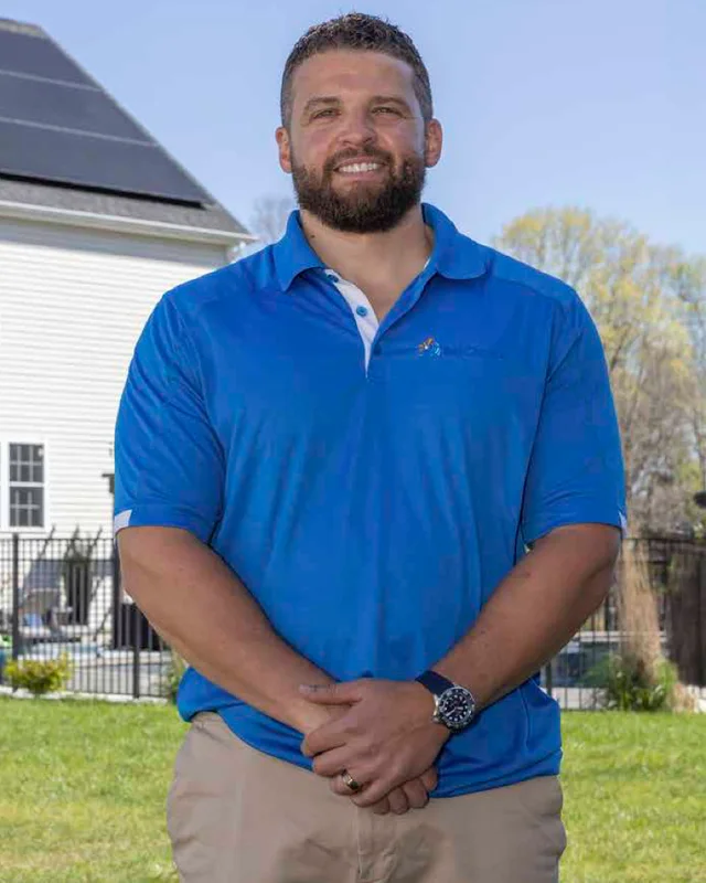 Jeff Amanna of Sol Choice standing outside a home with rooftop solar panels
